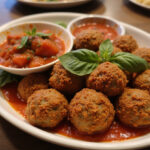 Finished 4C breadcrumbs meatballs with marinara sauce and basil, ready to eat.