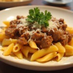 Finished Cheesy Beef and Bowtie Pasta in Garlic Butter, garnished with parsley and Parmesan.