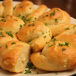 Delicious Homemade Cunetto's Garlic Cheese Bread with melted cheese and parsley garnish.