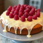 Finished Raspberry Lemon Cake with fresh raspberries and lemon glaze, perfect for dessert.