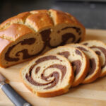 Sliced homemade marble rye bread showing marbled pattern.