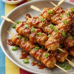 Deliciously plated Bang Bang Chicken Skewers, perfect for summer barbecues or dinner parties, highlighting the flavors and presentation.