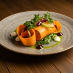 A stunning carrot ribbon salad presented on a rustic plate, showcasing vibrant colors and textures, perfect for a healthy meal.