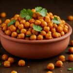 Crispy chili roasted chickpeas served in a bowl. Enjoy this healthy snack that is perfect for parties or as a quick treat.