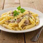 Final presentation of creamy cheesy penne with garlic butter ground beef, a comforting and delicious pasta dish ready to be served.