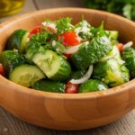 A beautifully arranged serving of marinated cucumbers, onions, and tomatoes in a rustic bowl, ready to be enjoyed.