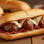 Delicious close-up of a Bourbon BBQ Bacon Cheeseburger Meatball Sub, highlighting melt-in-your-mouth meatballs and cheese
