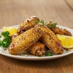 Delicious lemon pepper wings drizzled with honey and garnished, presenting the final dish in a mouth-watering display.